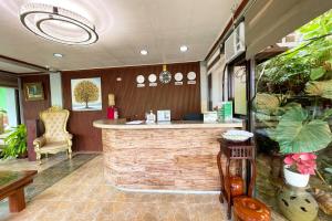 a lobby with a bar with a chair and plants at Kamayan sa Palaisdaan Hotel and Resort Quezon in Lucban