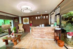 a lobby with a bar and a table at Kamayan sa Palaisdaan Hotel and Resort Quezon in Lucban