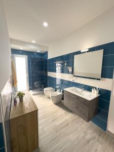 a bathroom with a sink and a toilet and a mirror at Ferrera Suite & Rooms in Misterbianco +78 photos