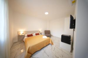 a bedroom with a bed and a flat screen tv at La Casa Di Nonna in Licusati