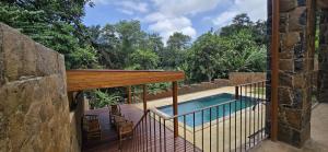 a balcony with a swimming pool on a house at Moradia Pérola da Natureza in Lemos