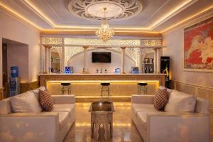 a living room with two couches and a bar at Orient Star Varahsha in Bukhara
