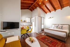 a bedroom with a bed and a living room at Blerina's Agritourism Concept in Laknas