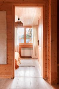 an open door into a bedroom with a bed and a window at Domki Bystre in Baligród