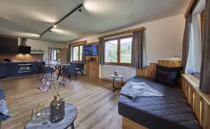 a living room with a couch and a table at Chalet Wallehen by we rent, JOKERCARD INCLUDED in Saalbach-Hinterglemm