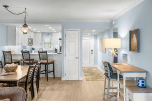 a kitchen and dining room with a table and chairs at Sunset Captiva Bayside Unit 103 condo in Captiva