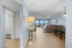 a living room and dining room with a couch and a table at Sunset Captiva Bayside Unit 103 condo in Captiva