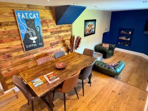 a dining room with a large wooden table and chairs at High Cross House in Millbrook +26 photos