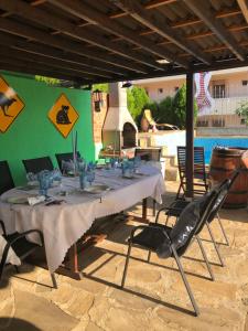 a long table with chairs and a swimming pool at Villa Rocky in Sozopol
