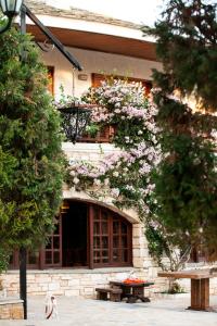 a building with a tree with pink flowers on it at A&Bpikermistudios2 in Pikérmion