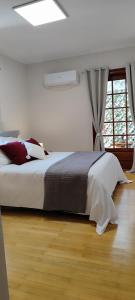 a bedroom with a bed and a window at A&Bpikermistudios2 in Pikérmion
