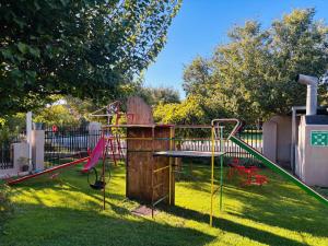 a park with a playground in the grass at Hendersons Lodge Ltd in Senekal