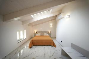 a bedroom with a bed in a white room at La Casa Di Nonna in Licusati