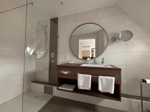 a bathroom with a sink and a mirror at Hotel Krone Neuenburg in Neuenburg am Rhein