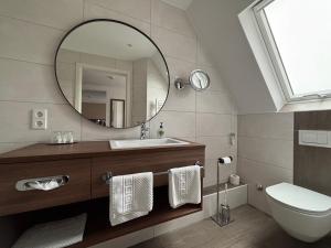a bathroom with a sink and a mirror at Hotel Krone Neuenburg in Neuenburg am Rhein