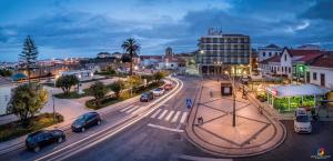 a city with cars parked on a street at night at Residência Aviz in Peniche