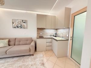 a living room with a couch and a kitchen at Villa Sunrice in Nea Peramos +56 photos