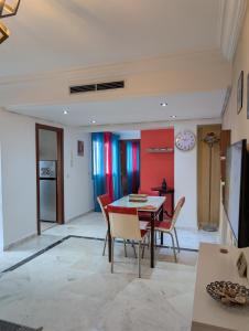 a kitchen and dining room with a table and chairs at Tanger City 2 in Tangier