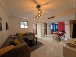 a living room with a couch and a table at Tanger City 2 in Tangier