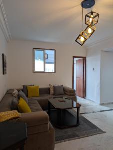a living room with a couch and a table at Tanger City 2 in Tangier