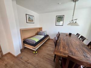 a bedroom with a bed and a wooden table at Binder's Ferienhaus zur Altmühl in Leutershausen
