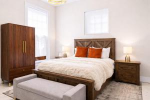 a bedroom with a large bed and a chair at Charming 7BR Home Bourbon Trail & Attractions in Louisville