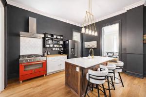 a kitchen with a red stove and white cabinets at Charming 7BR Home Bourbon Trail & Attractions in Louisville