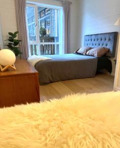two beds in a bedroom with a yellow blanket at Torvika Hus in Isfjorden +32 photos