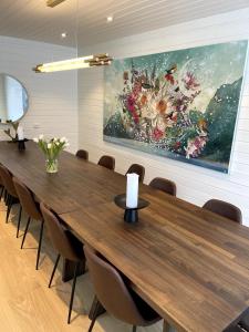a conference room with a large painting on the wall at Torvika Hus in Isfjorden