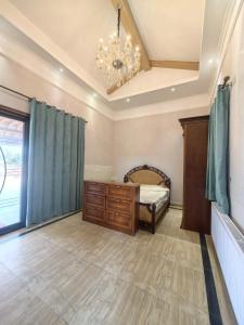 a bedroom with a bed and a chandelier at Xiannv Mountain House in Chongming