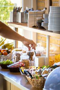 a person preparing food on a counter with food at CentralHotellet in Køge
