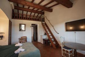 a room with a bed and a television and a table at Chambre bleue Villalormarin in Saint-Tropez