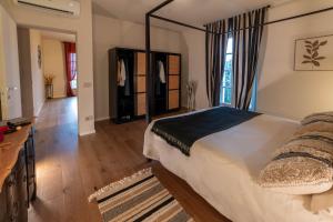 a bedroom with a large bed and a room with a hallway at Ca' Mariet Langhe in Guarene