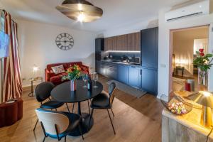 a kitchen and living room with a table and chairs at Ca' Mariet Langhe in Guarene