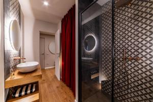 a bathroom with a red shower curtain and a sink at Ca' Mariet Langhe in Guarene +18 photos