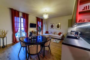 a kitchen and living room with a table and chairs at Ca' Mariet Langhe in Guarene