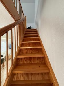 a staircase with wooden treads in a house at Wittower Heide 40-1 in Glowe