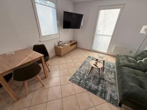 a living room with a couch and a table at Wittower Heide 40-1 in Glowe