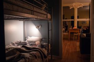 a bedroom with a bunk bed and a living room at Nävekvarns Skärgårdscamping in Nävekvarn