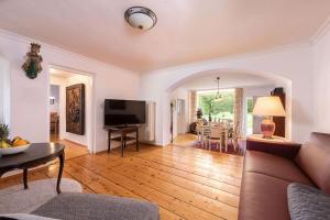 a living room with a couch and a table at Villa Marga Ferienwohnung Jenner in Schönau am Königssee