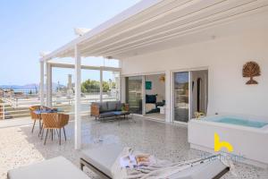 a house with a swimming pool and a living room at Sun-Splashed Top-Floor APT with Seaview and Jacuzzi! in Vari