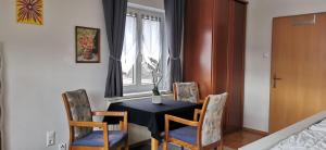 a dining room with a black table and chairs at Lake View in Millstatt