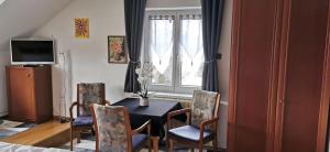 a dining room with a table and chairs and a window at Lake View in Millstatt