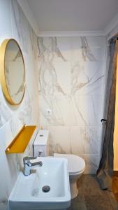 a bathroom with a sink and a toilet and a mirror at Cascais Garden House in Cascais +35 photos