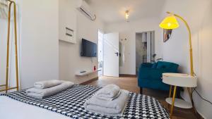 a bedroom with a bed and a blue chair at Cascais Garden House in Cascais