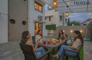 a group of women sitting at a table at EKOSTAY - Ivana Villa in Lonavala