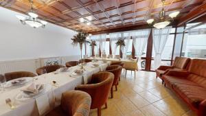 a dining room with long tables and chairs at Pribina Penzión in Nitra
