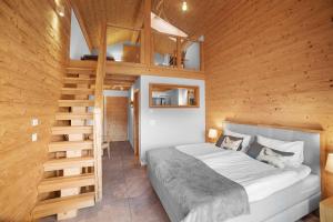a bedroom with a bed and a wooden wall at Chalet Diognysos B&B, Wellness & Boutique Hotel, Valais Crans-Montana Diogne in Crans-Montana