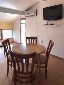 a dining room with a wooden table and chairs at Villa Rocky in Sozopol