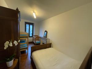 a bedroom with a bed and a tv in it at souvenirs rignacois in Rignac